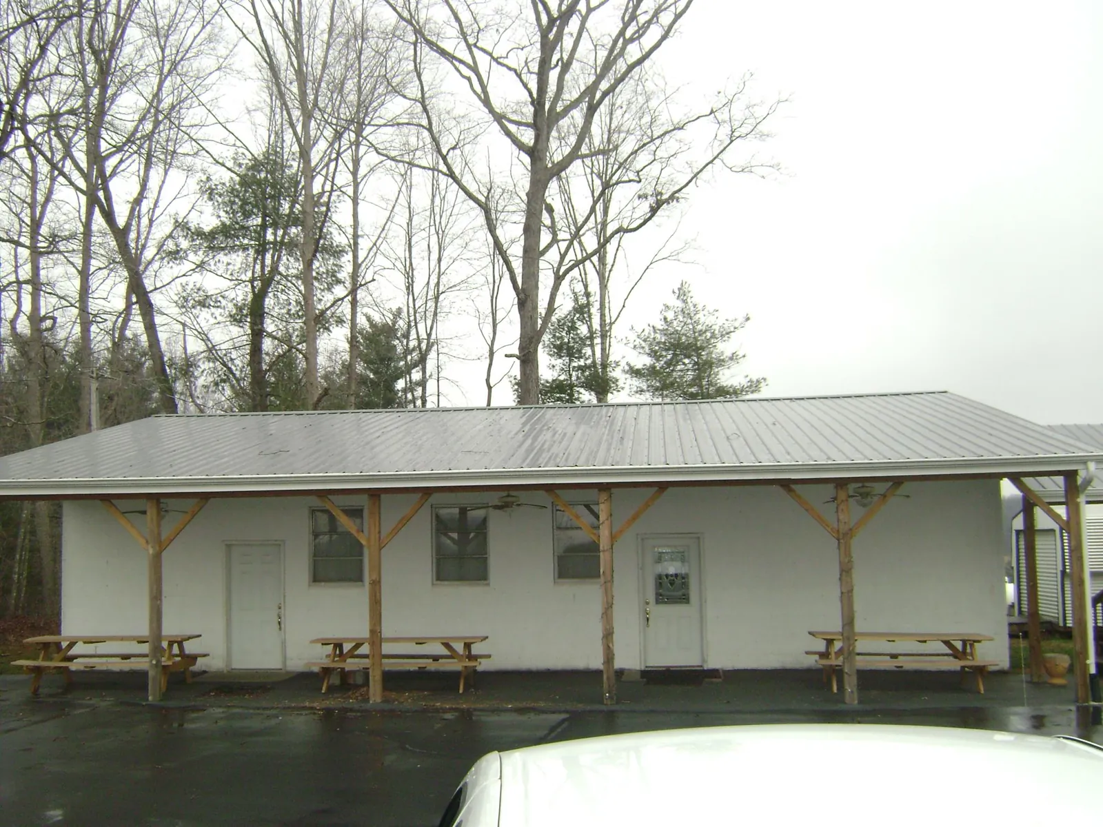 Gray metal roof over a block building with a timber post porch in South Heart